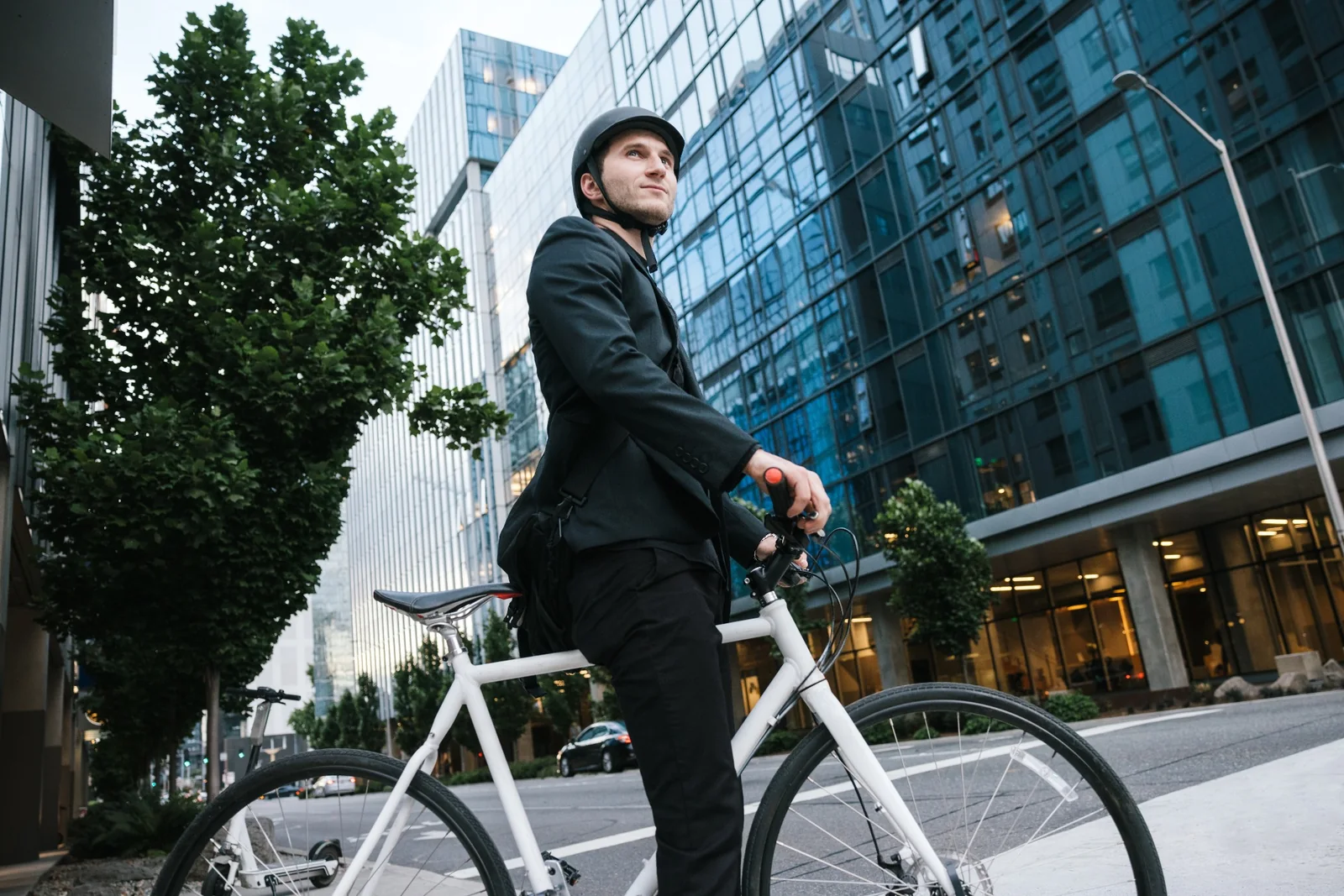 A cyclist with a bicycle on a downtown city street
