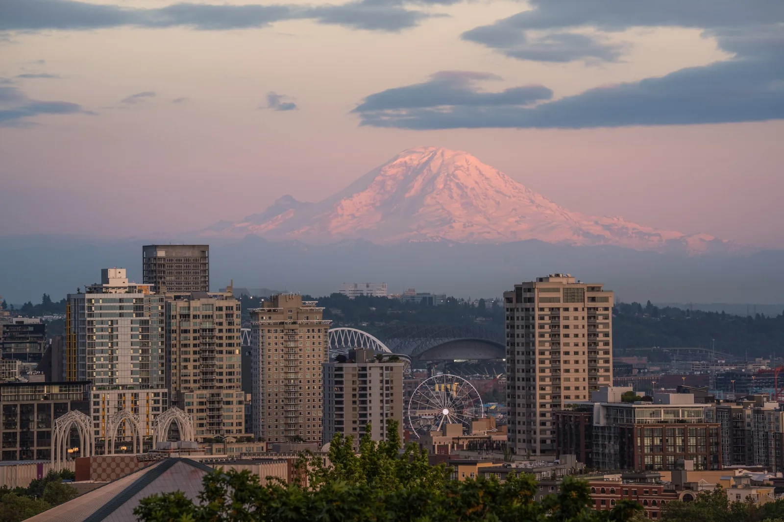 Mount Rainier above the Seattle skyline at sunset