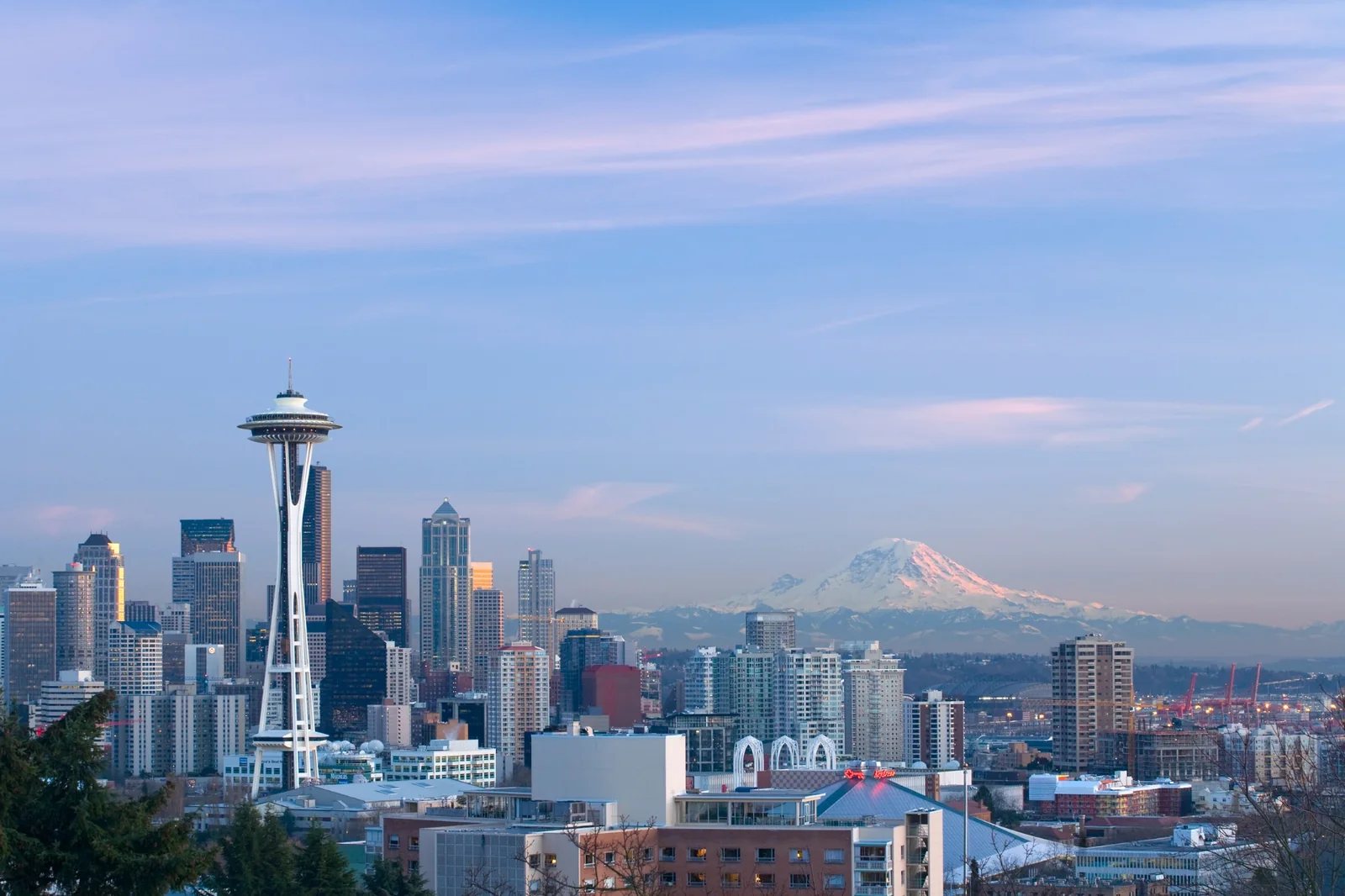 Seattle skyline and Mount Rainier under a soft blue sky
